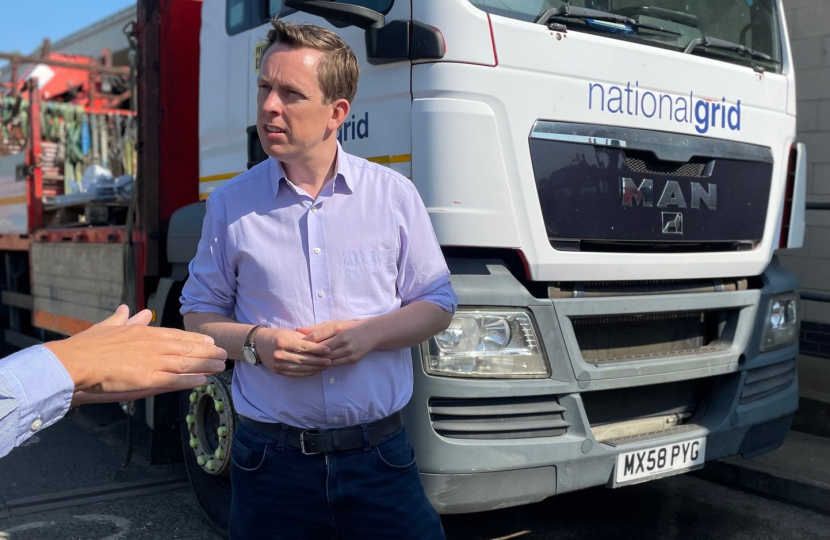 Tom in discussion with a representative from the National Grid. Behind him is parked a 'national grid' vehicle.