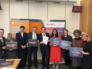Tom stood with nine other people who are holding plaques which read 'From the 27th 2023, Child Marriage in England and Wales will be a crime.'